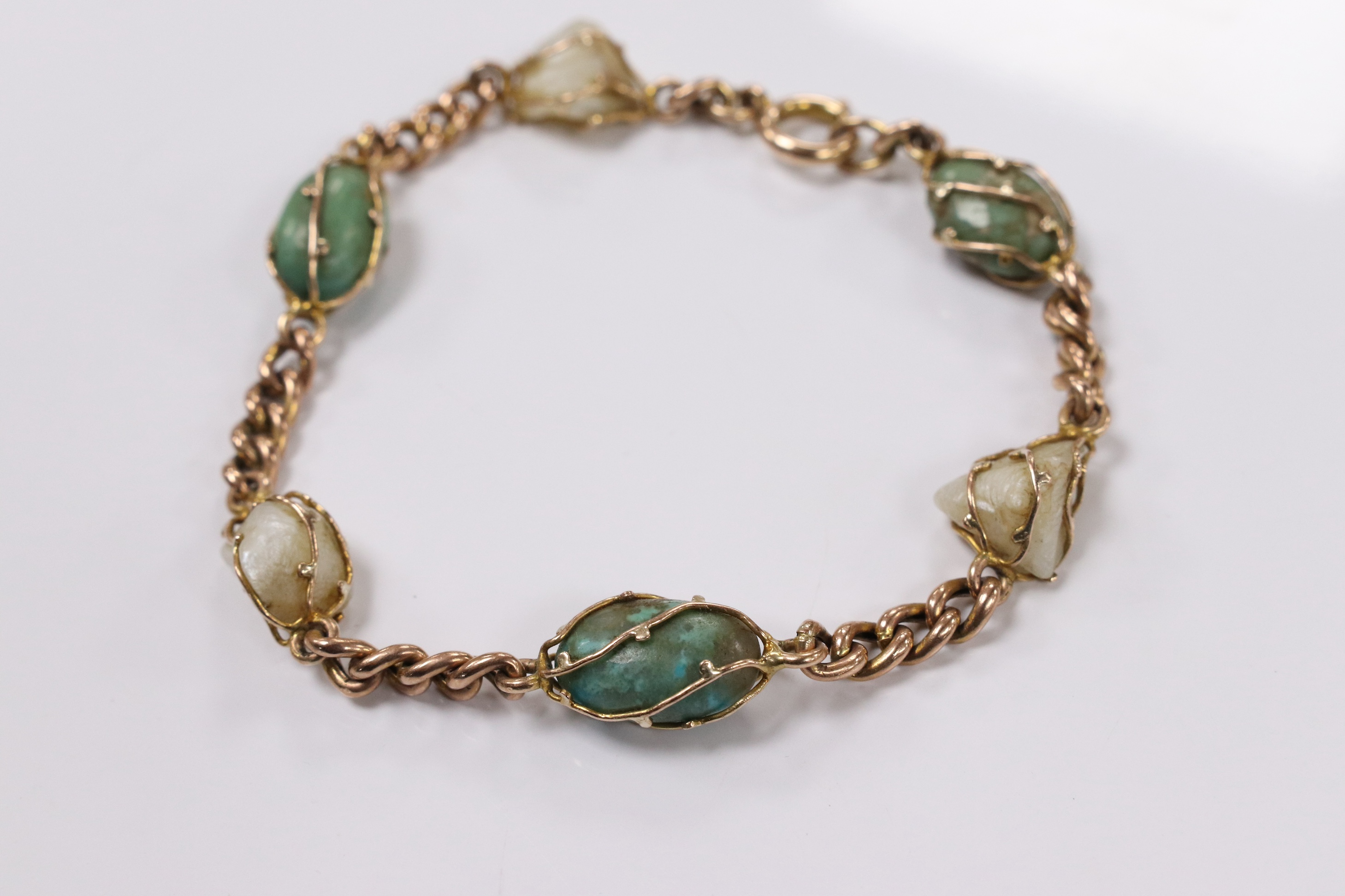 An early 20th century yellow metal, turquoise and baroque pearl set curb link bracelet, 18cm, gross weight 11.1 grams. Condition - fair